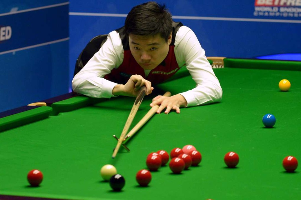 China's Ding Junhui gives England’s Mark Williams a lesson at the world championships in Sheffield. Photo: AP