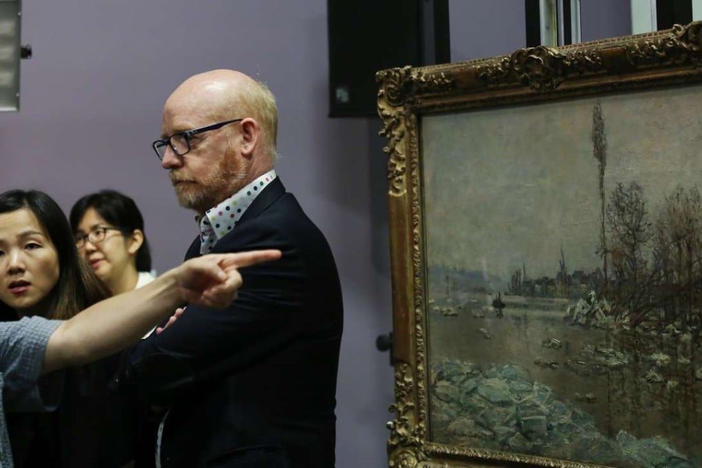 Exhibition curator Bruno Girveau with Monet’s The Break-Up of the Ice at Vétheuil, facing Lavacourt. Photo: Jonathan Wong
