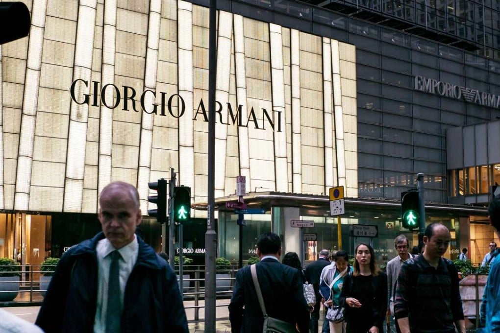 The neon emblazeond sign of a Giorgio Armani SpA luxury store in the Central district of Hong Kong, China as advertising spending in the city declined in the first quarter of 2016. Photo: Bloomberg
