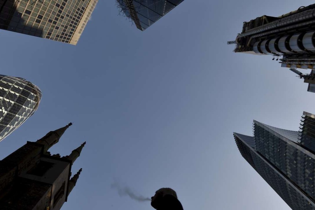 A city worker walks through the City of London, Britain’s banking nerve centre. Photo: Reuters