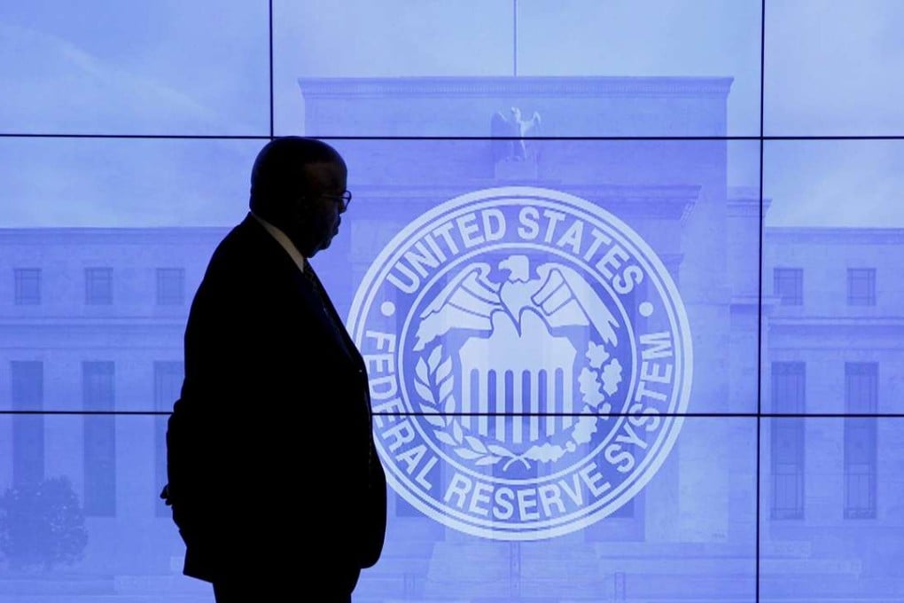 A security guard walks in front of an image of the Federal Reserve following the two-day Federal Open Market Committee (FOMC) policy meeting in Washington where they kept US interrest rates unchanged. Photo: Reuters