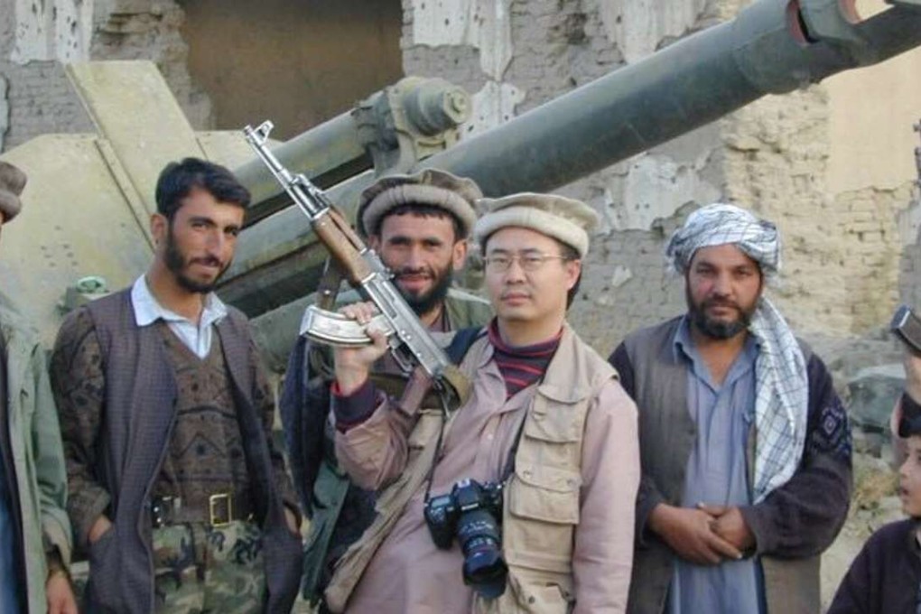 Andrei Chang, centre, pictured in 2001 in Kabul, Afghanistan with fighters from the pro-US Northern Alliance who had just driven the Taliban from the city. Photo: Andrei Chang