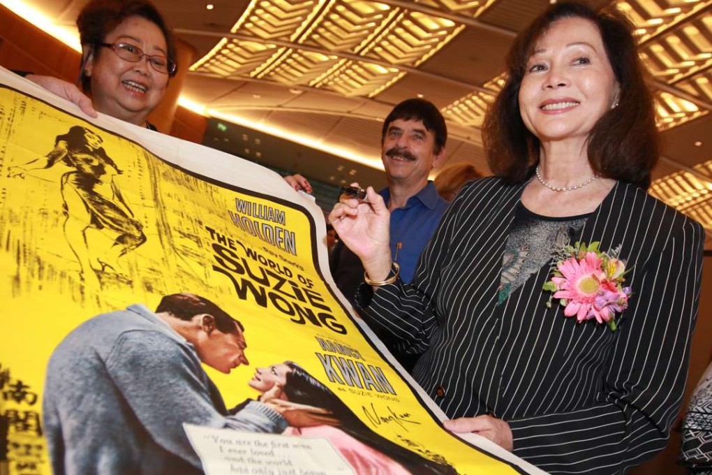Nancy Kwan, star of the movie “The World of Suzie Wong”, signs a poster 50 years after the film’s release. Photo: Felix Wong