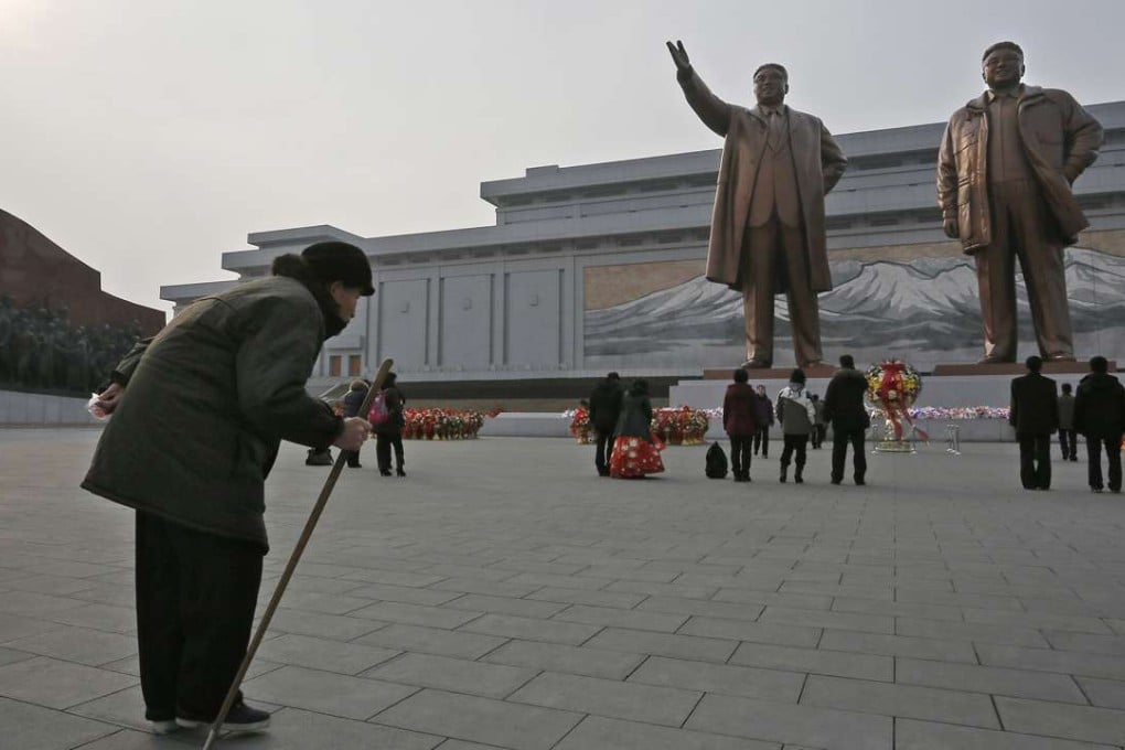 A elderly man bows before statues of Kim Il-sung and Kim Jong-il in Pyongyang. A new documentary has shown how the state ceaselessly manipulates the people. Photo: AP