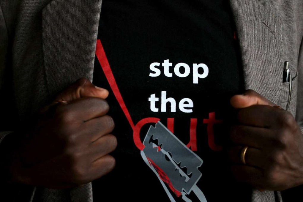 A man shows the logo of a T-shirt that reads "Stop the Cut" referring to Female Genital Mutilation (FGM) during a social event advocating against harmful practices such as FGM at the Imbirikani Girls High School in Imbirikani, Kenya on April 21, 2016. Photo: Reuters