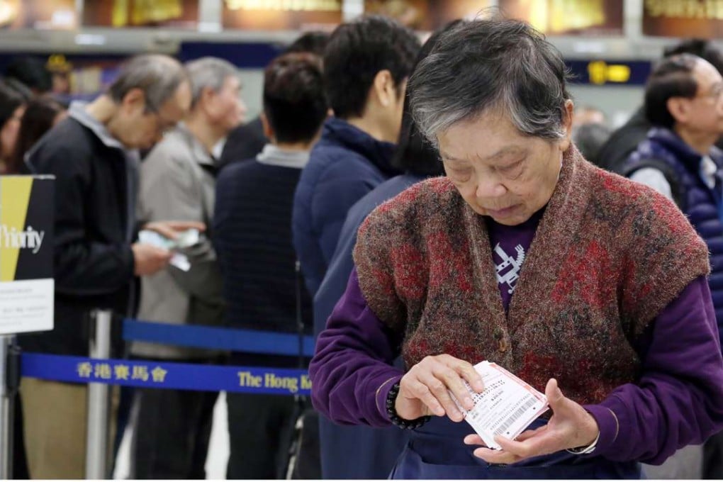 An elderly woman buying Mark Six tickets. Some old people in Hong Kong are still confronted with financial difficulties, so what is the government doing about that? Photo: Nora Tam