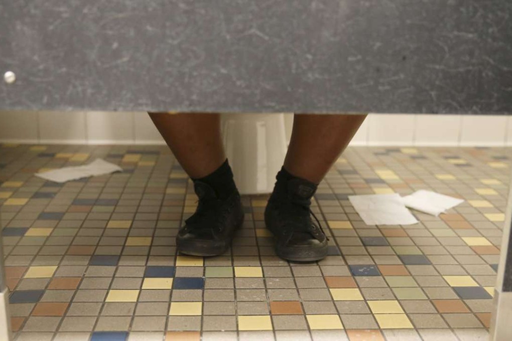 Someone sitting on a toilet. Photo: Reuters