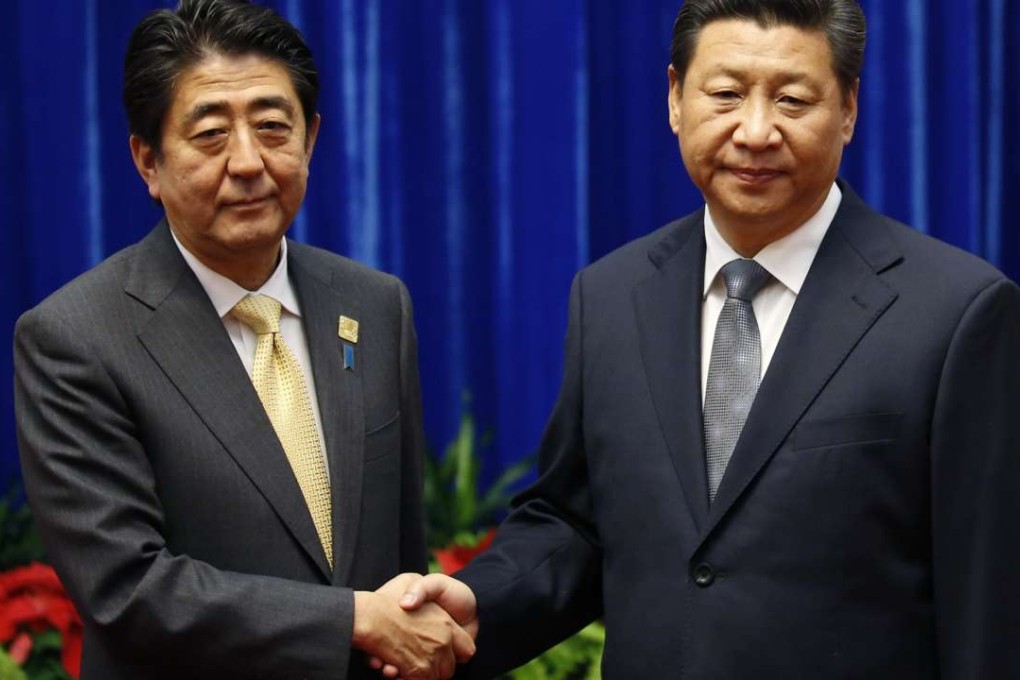 The less-than-delighted expressions on Chinese President Xi Jinping (right) and Japanese Prime Minister Shinzo Abe’s faces in this 2014 handshake underscore the uneasy relationship between the two states. Photo: Reuters