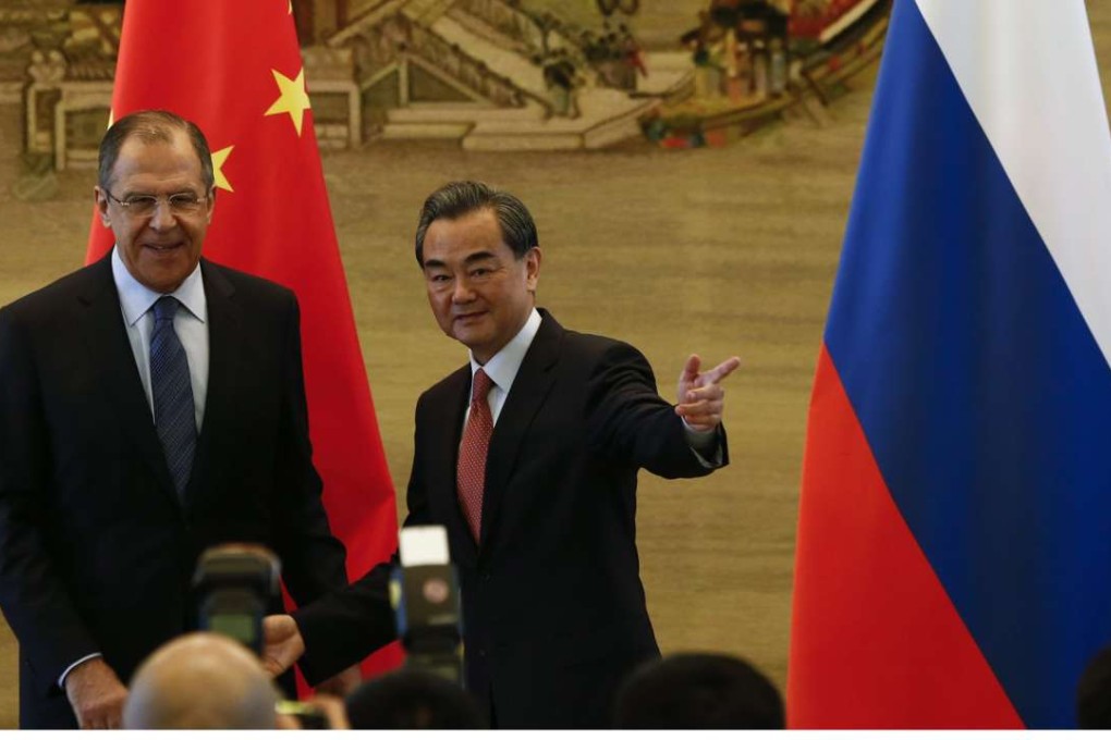 Russian Foreign Minister Sergey Lavrov (left) and his Chinese counterpart Wang Yi prepare to leave after a joint press conference at the Foreign Affairs Ministry in Beijing on Friday. Photo: EPA