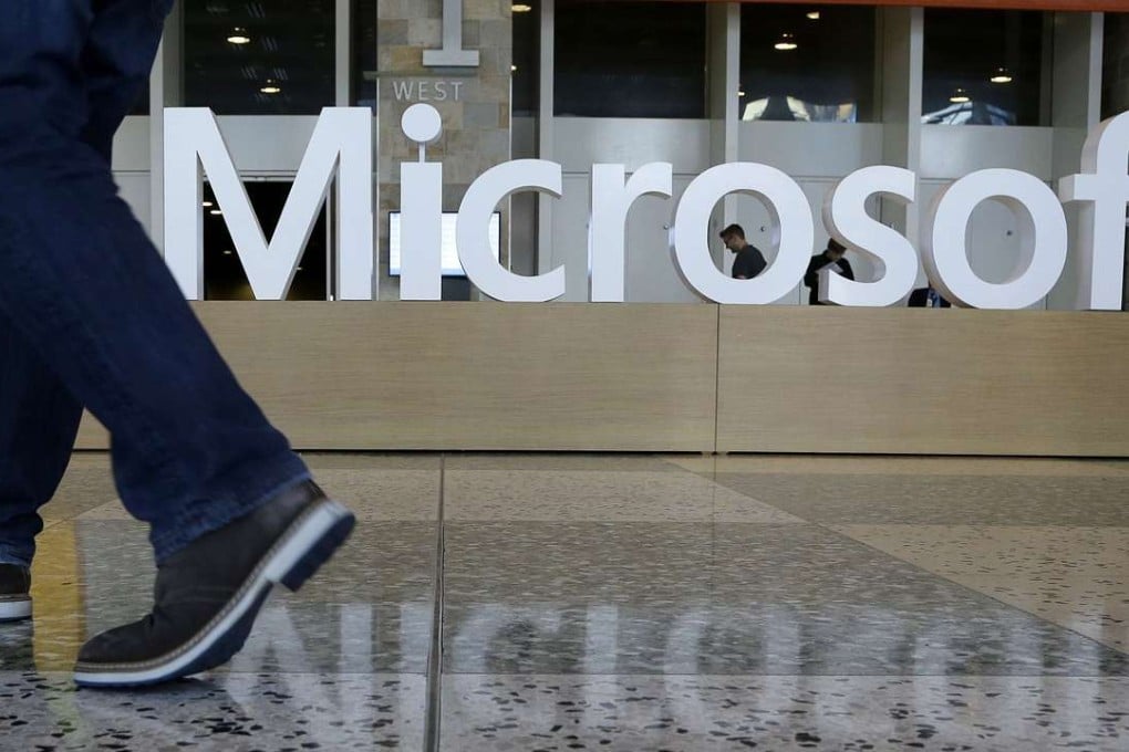 A man strides past a Microsoft sign set up for the Microsoft BUILD conference at Moscone Center in San Francisco. Photo: AP