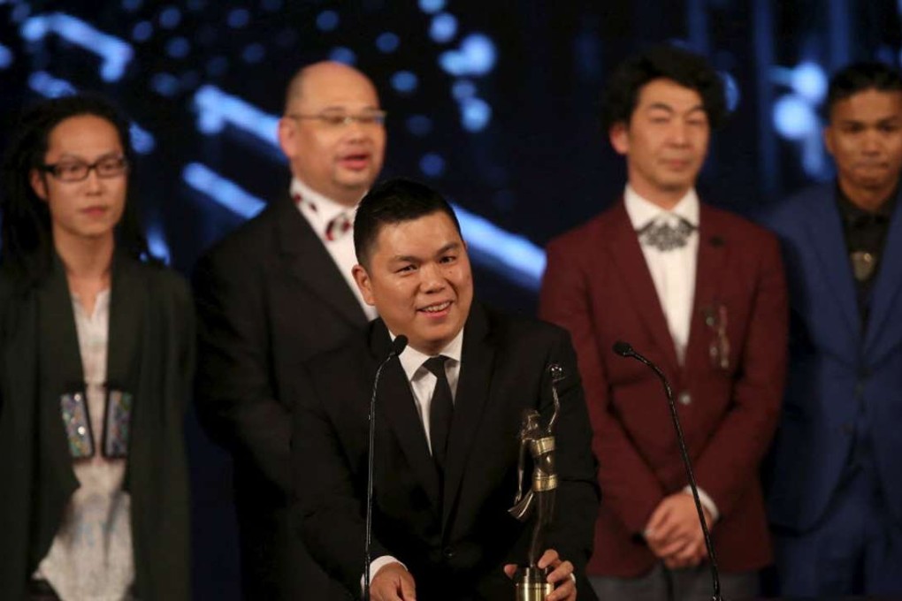 Executive producer Andrew Choi (C) speaks in front of directors and cast members of movie “Ten Years” after winning the Best Film award at the Hong Kong Film Awards in Hong Kong. Photo: Reuters