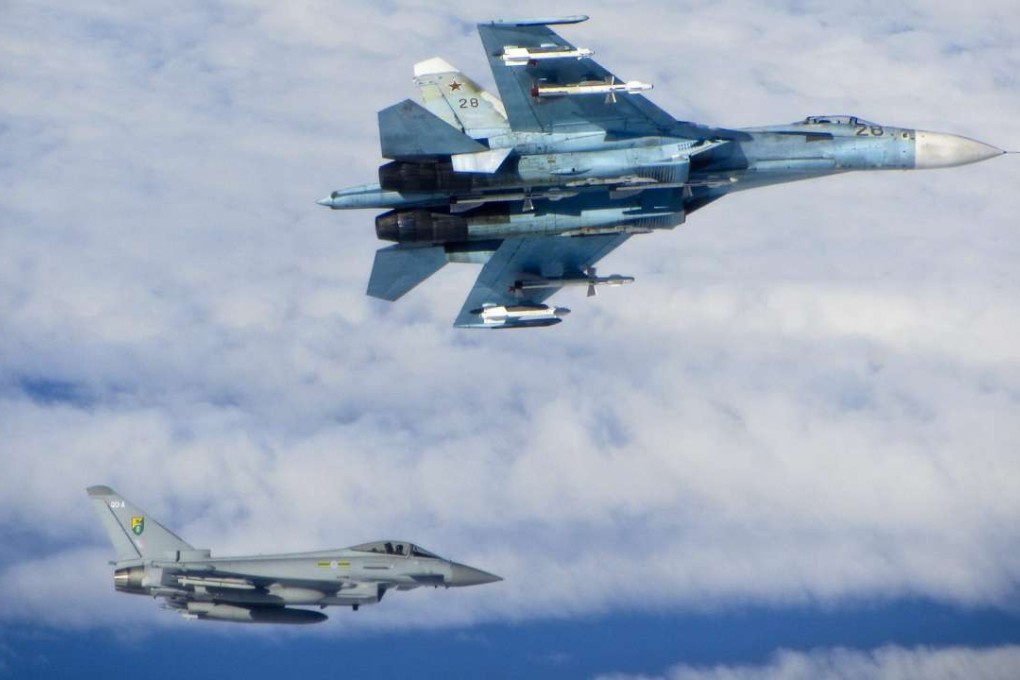 A Royal Air Force Typhoon fighter (bottom left) shadows one of four Russian Sukhoi Su-27 Flanker fighters, like the one involved in Friday’s incident, in Baltic air space in June 2014. File photo: EPA