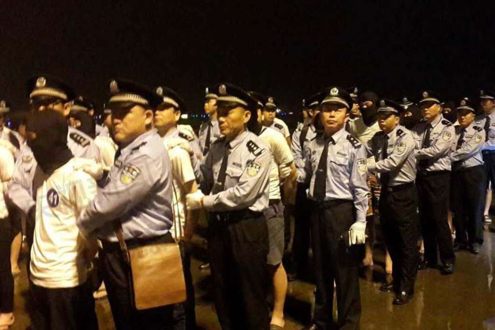 Police escort the latest suspects in Guangzhou after being flown to mainland China from Malaysia on Saturday evening. Photo: CCTV