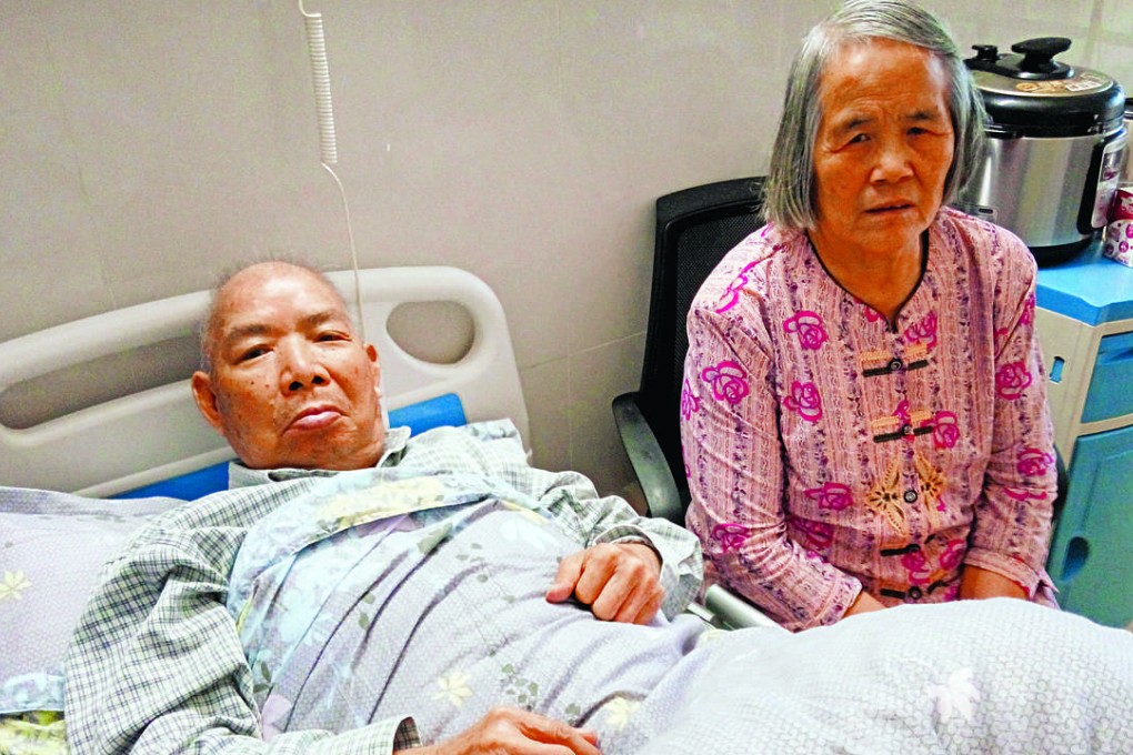 Chen Wenying (right) with her husband in a Guangzhou hospital where he is recovering from a stroke. Photo: SCMP Pictures