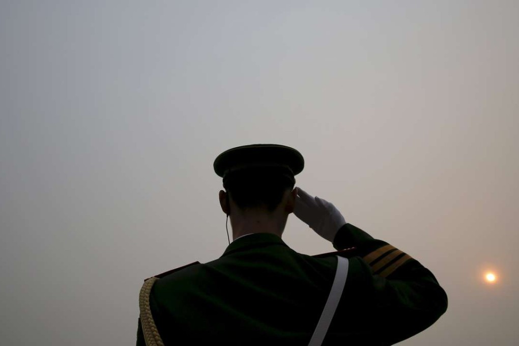 The sun appears through thick smog as a paramilitary policeman salutes delegates arriving at the Great Hall of the People before the opening ceremony of the National People's Congress in Beijing this year. Photo: Reuters