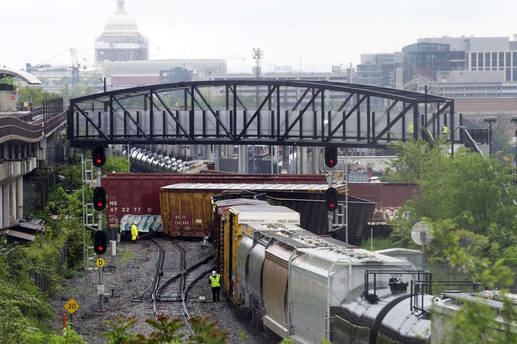 Emergency workers at the scene after a CSX freight train derailed in Washington on Sunday. Photo: AP
