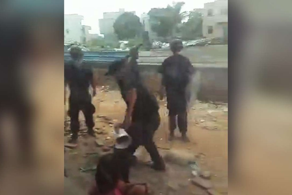 An officer seen striking a villager during the security operation in Hainan. Photo: Sohu.com