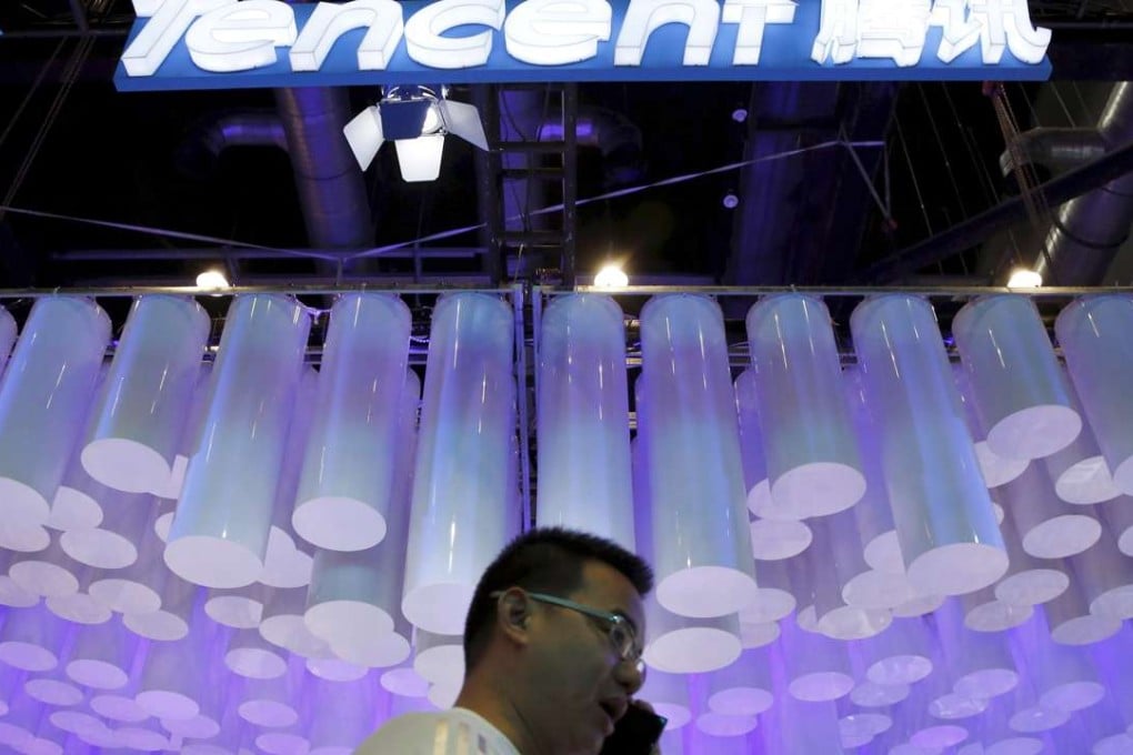 A man talks on his phone at a mobile internet conference in Beijing in this file photo from April last year. Companies like Baidu, Alibaba and Tencent will lead the development of the online finance sector, People’s Daily says. Photo: Reuters