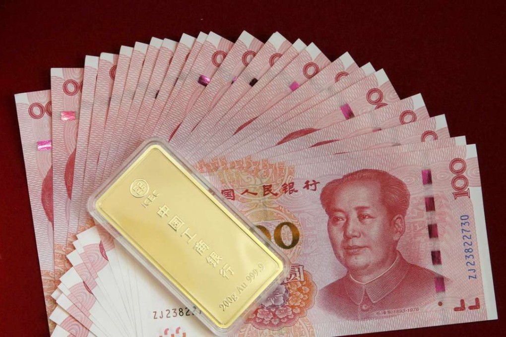 AN ICBC Bank's gold product is pictured with Chinese 100 yuan banknotes in this illustration photo taken April 13, 2016. Photo: Reuters