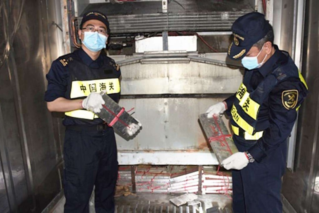 Customs officers with the massive haul of silver plates found on the refrigerator truck. Photo: Shenzhen Customs District PRC
