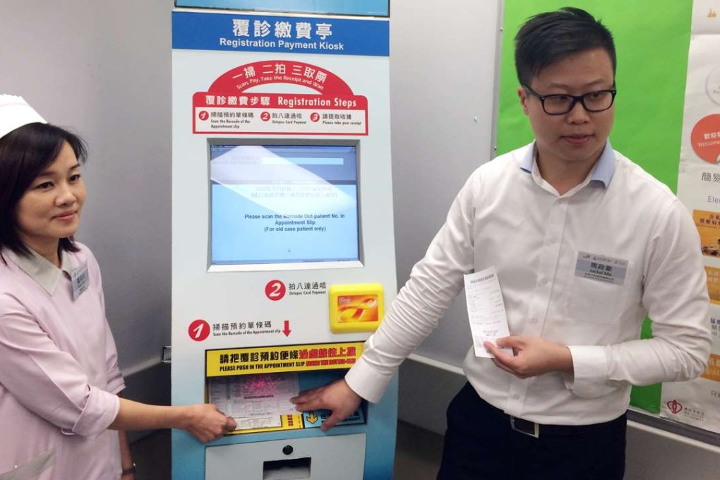 Esther Wong, ward manager at United Christian Hospital’s orthopaedics outpatient clinic, and analyst programmer Jackel Ma demonstrate how patients register on arrival. Photo: Elizabeth Cheung
