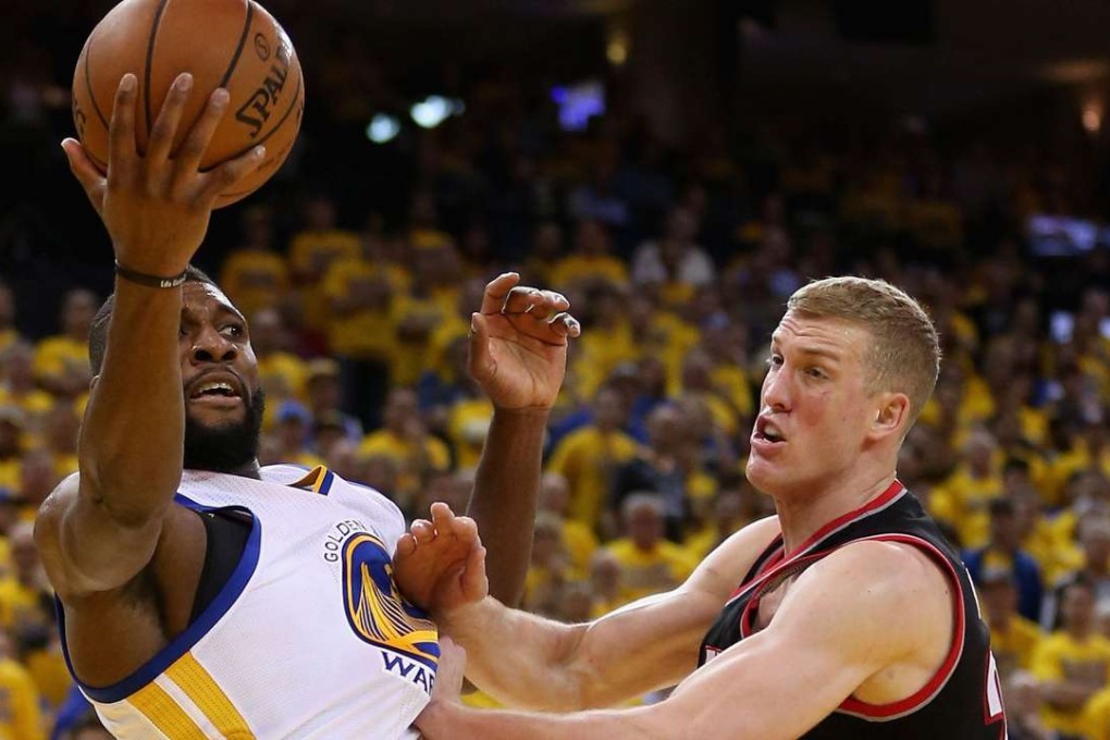 Festus Ezeli of the Golden State Warriors and Mason Plumlee of the Portland Trail Blazers go for a rebound. Photo: AFP