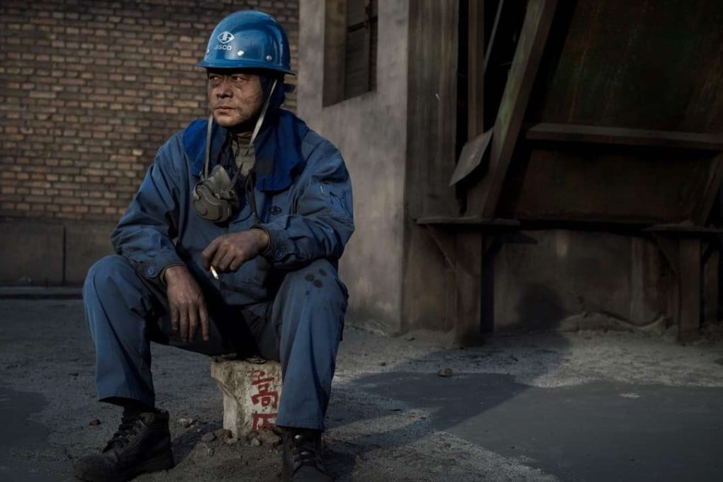 A worker from the Jiuquan Iron and Steel company in Jiayuguan, west of Beijing, takes a break. Photo: AFP