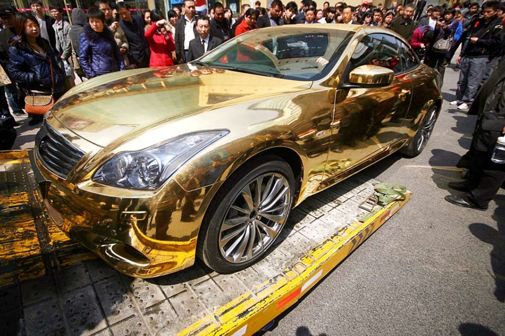 Conspicuous shows of wealth have appeared in China like this gold car in Nanjing city. Its owner parked and left, attracting a big crowd. Ten minutes later, police towed the car away due to illegal parking. Photo: China Foto Press