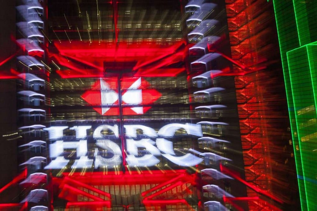 The HSBC logo lit up on the exterior of the bank’s headquarters building in Hong Kong. Photo: EPA