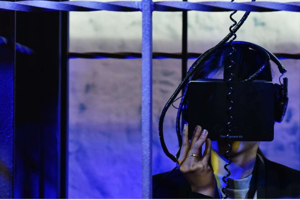 A woman wears virtual reality head gear. Photo: Xinhua