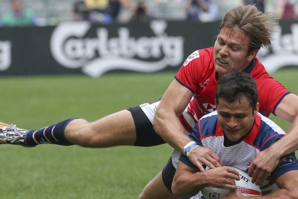 Hong Kong’s Ryan Meacheam tackles Cayman Islands back Robbie Cribb during a pool match at the Hong Kong Sevens last month. Photo: Felix Wong/SCMP
