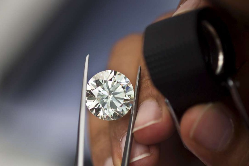 A trader inspects a diamond. Photo: Reuters