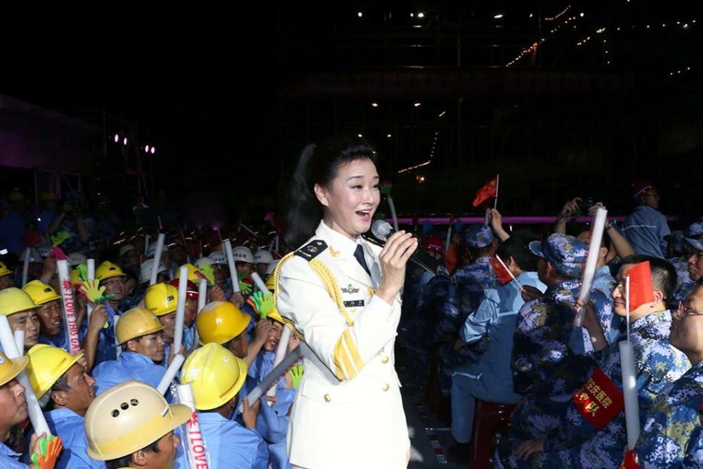 Chinese singer Song Zuying performing for workers and military personnel on Fiery Cross Reef located in the disputed Spratly Islands group in the South China Sea. One of China's top folk singers is rocking her away across disputed territory in the South China Sea, serenading hundreds of troops and construction workers stationed there, Chinese media reported on May 5. Photo: AFP
