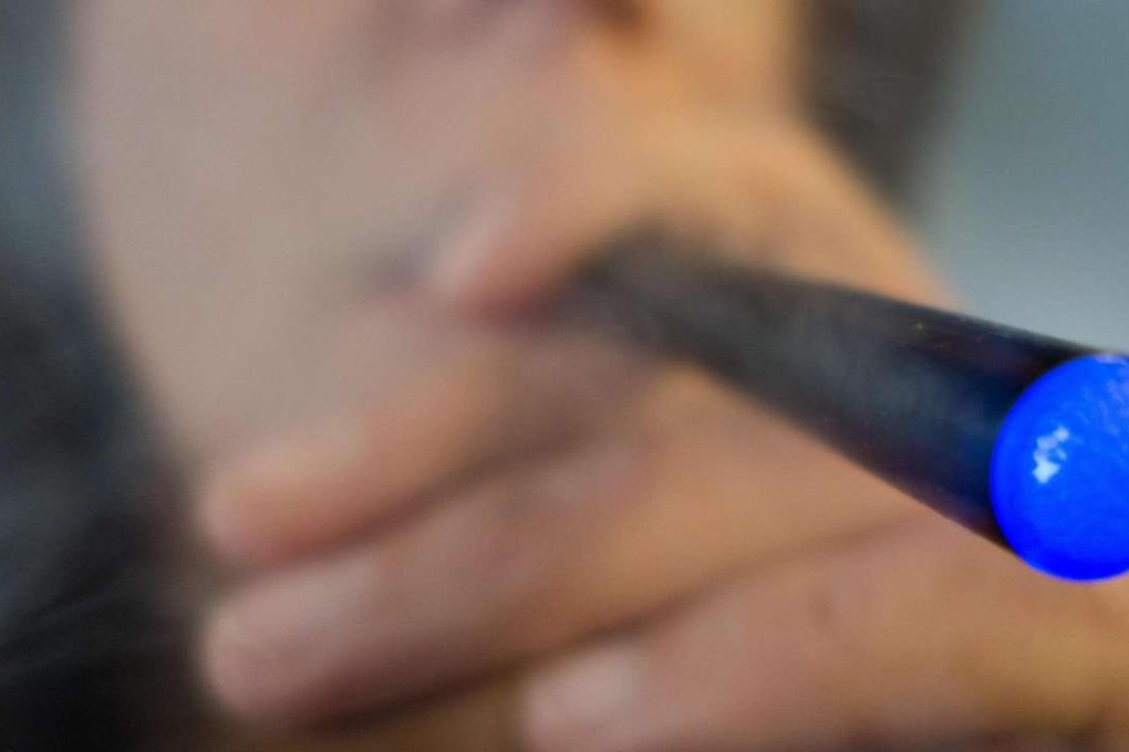 A woman is smoking a "Blu" e-cigarette as the United States issued a sweeping ban on sales of e-cigarettes, cigars, pipe tobacco and hookahs to those under 18. Photo: AFP