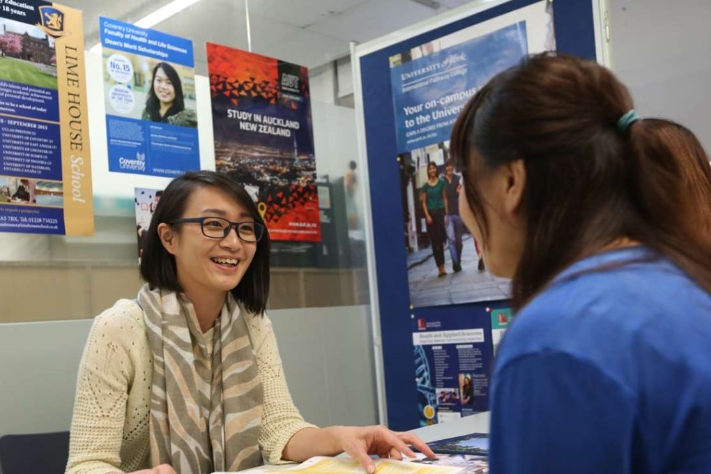 Yetta Kwan (left), senior education consultant, answers questions from students and parents who seek advice for studying abroad at AAS Education Consultancy in Mong Kok. Photo: Nora Tam