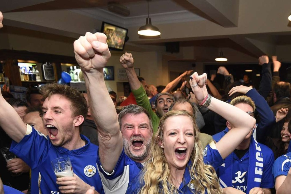 Leicester City supporters celebrate clinching the English Premier League title at a tavern in Leicester. Photo: EPA