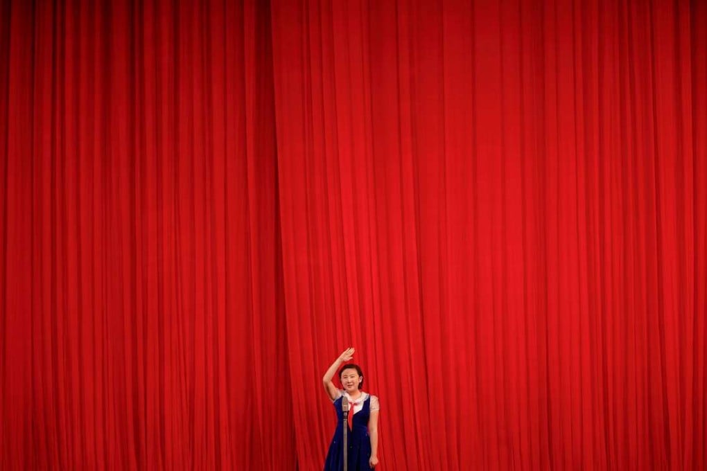 A girl welcomes visiting foreign journalists to the Mangyongdae Children’s Palace in Pyongyang. Photo: Reuters