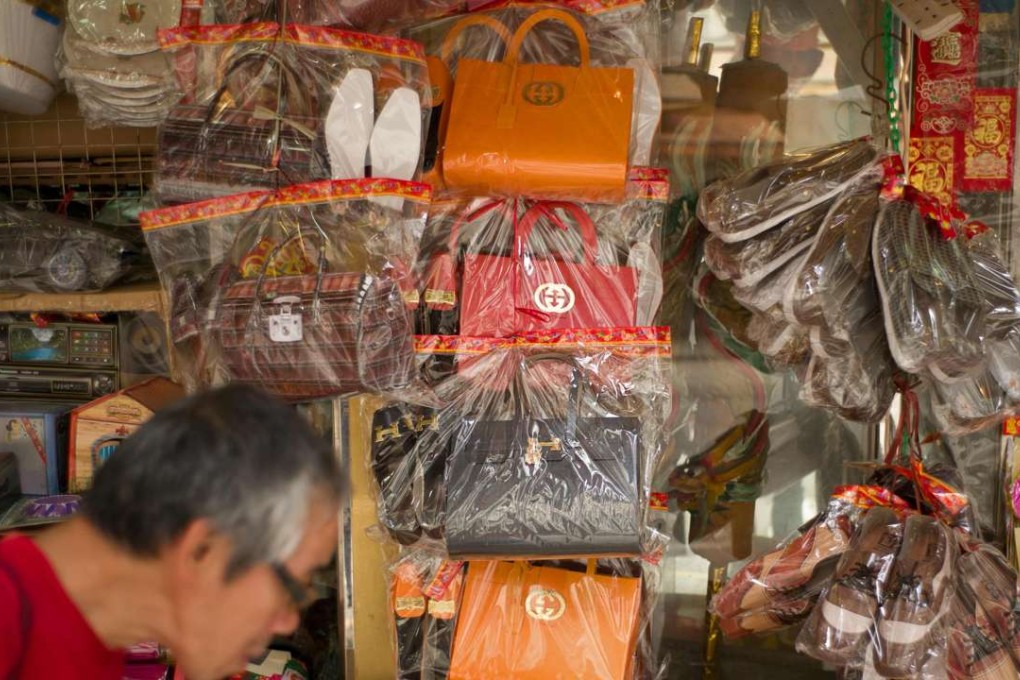 Paper tomb offerings are traditionally burned at funerals as gifts for the deceased to enjoy in the afterlife. Photo: AFP