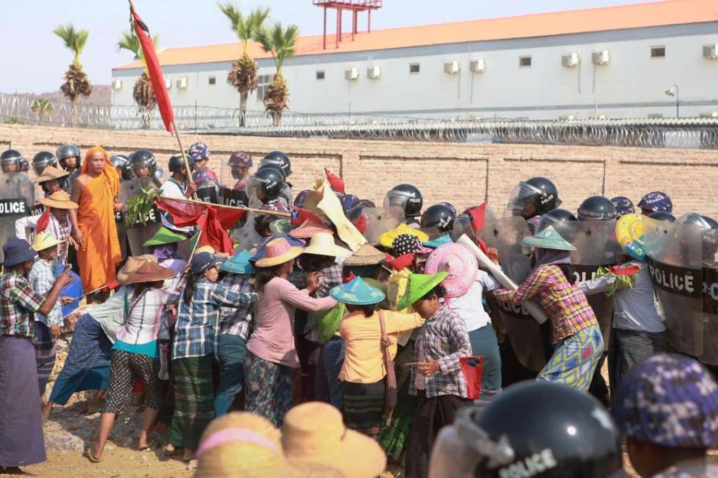 Protesters face off with policemen outside the Chinese-owned mining facility in the central Myanmar town of Monywa. Photo: AFP