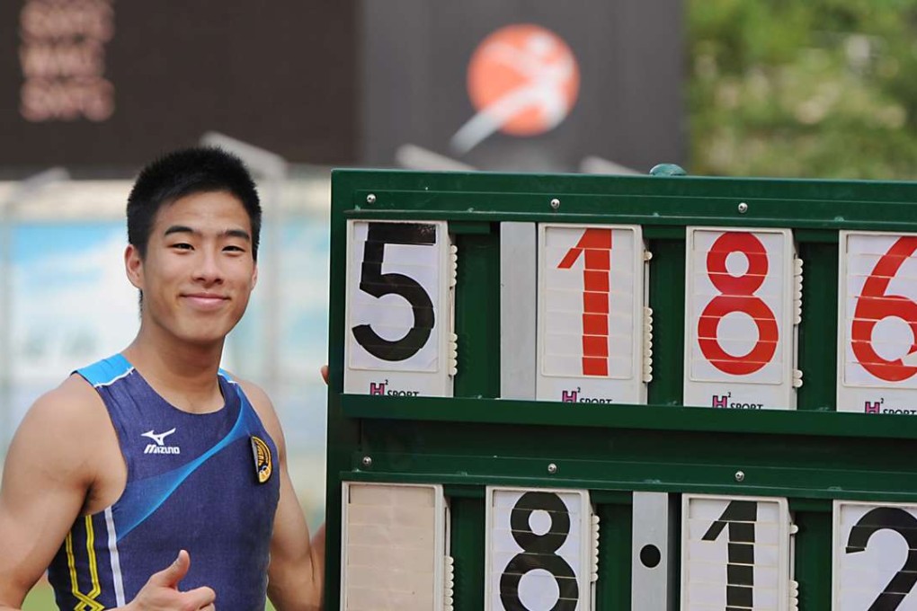 Hong Kong long jumper Chan Ming-tai poses next to the scoreboard. Photo: SCMP Pictures
