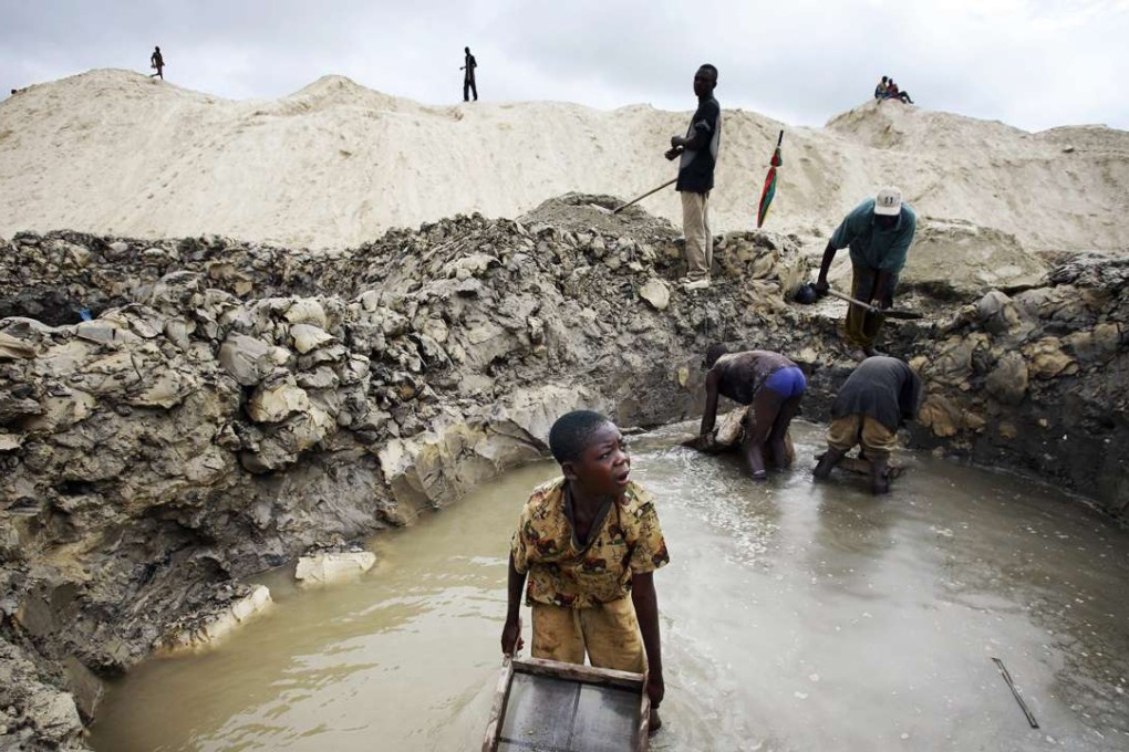 Young boys look for copper at the Ruashi mine, about 20km from Lubumbashi in the Democratic Republic of Congo. Photo: Getty Images
