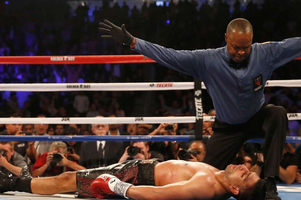 Amir Khan stays down after a knockout from Canelo Alvarez in their WBC middleweight title fight in Las Vegas. Photo: AFP