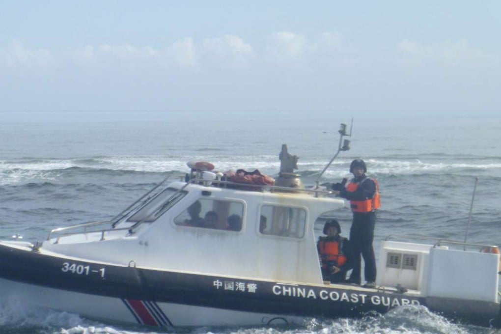 A Chinese coastguard boat approaches Filipino fishermen near Scarborough Shoal in the South China Sea last year. Photo: AP