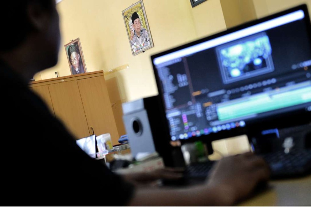 A squad of young Indonesian Muslims sit glued to the screen and fire out messages of a gentle Islam on social media. Photo: AFP