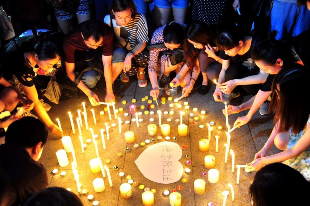 People hold a vigil for a retired dentist who died after being attacked by a former patient at home in Guangzhou, Guangdong province. Photo: Reuters