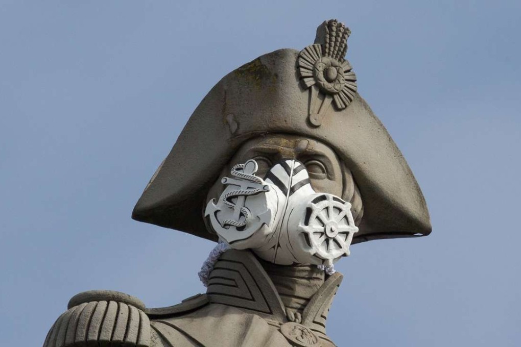 A nautical themed breathing mask is fixed to Lord Nelson's statue at the top of Nelson's Column in Trafalgar Square, central London on April 18, 2016. The stunt was part of a series that were carried out across the capital by Environmental protest group Greenpeace by adding masks to famous statues, to highlight air pollution in the capital. Photo: AFP