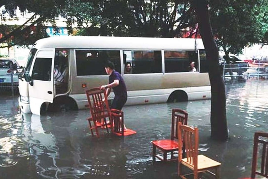 A minibus caught in floodwaters in Guangzhou. Photo: SCMP Pictures