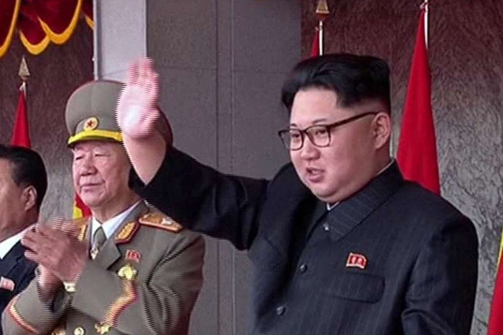 Leader Kim Jong-un presides over the parade and waves to the crowd. Photo: Screengrab