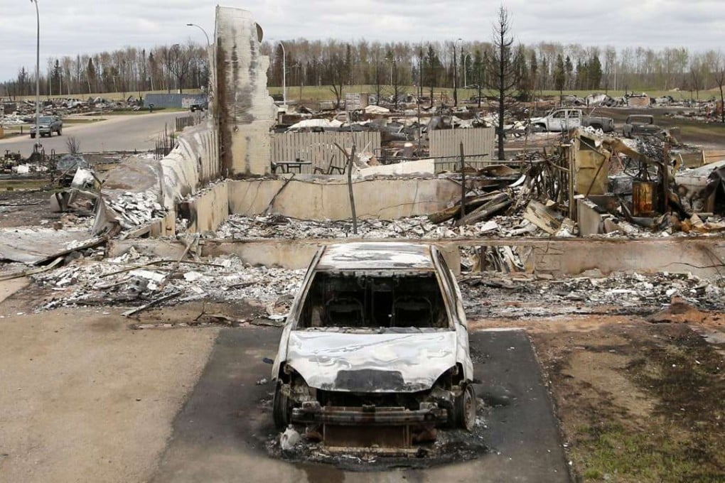 A charred vehicle and sits in the fire-razed neighbourhood of Beacon Hill in Fort McMurray, Canada, on Monday. Photo: AFP