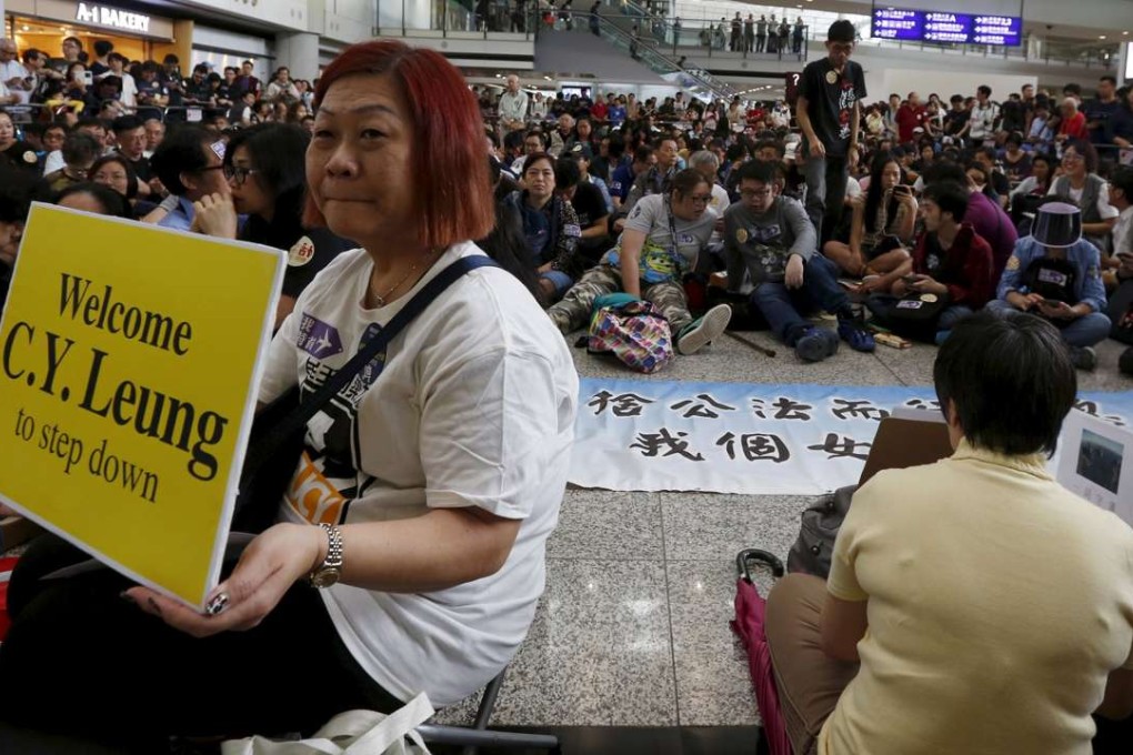 More than 1,000 people protested at the Hong Kong airport against Leung Chun-ying’s alleged abuse of power. Photo: Reuters